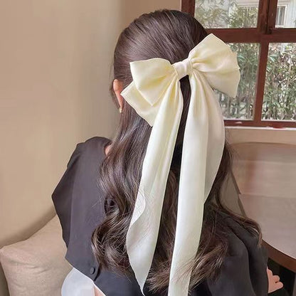 Large elegant bow, long flowing ribbon, simple but effective spring clip hairpin
