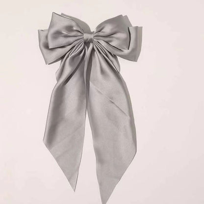 Large elegant bow, long flowing ribbon, simple but effective spring clip hairpin