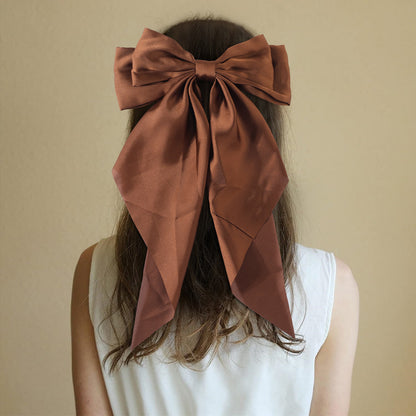 Large elegant bow, long flowing ribbon, simple but effective spring clip hairpin